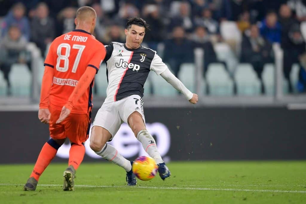 TURIN, ITALY - DECEMBER 15:  Cristiano Ronaldo of Juventus competes for the ball with Sebastien De Maio during the Serie A match between Juventus and Udinese Calcio on December 15, 2019 in Turin, Italy.  (Photo by Daniele Badolato - Juventus FC/Juventus FC via Getty Images)